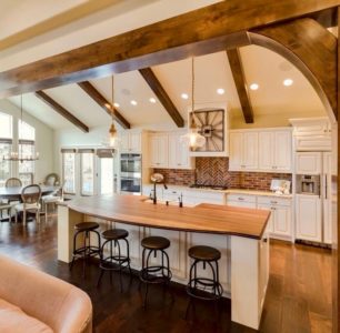 Beautiful custom white kitchen with natural wood accents and beams. Idaho Falls Home Builders